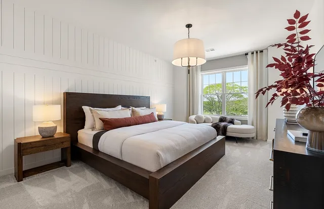 a bedroom with bed and a chandelier