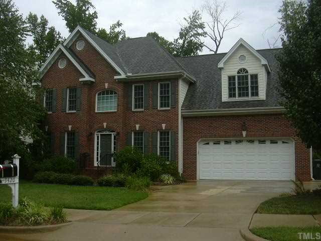 9420 Stone Mountain Road Raleigh, NC 27613 - Photo 1 of 12 a front view of a house with a yard and garage