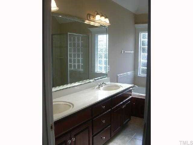 9420 Stone Mountain Road Raleigh, NC 27613 - Photo 9 of 12 a bathroom with a sink and a mirror