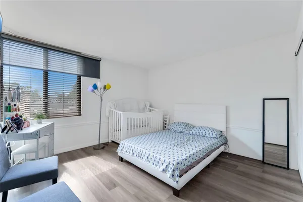 a bedroom with a bed and a couch