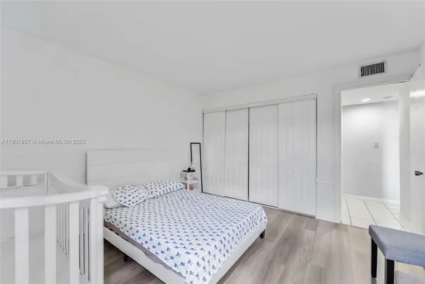 a bed sitting in a bedroom next to a bathroom