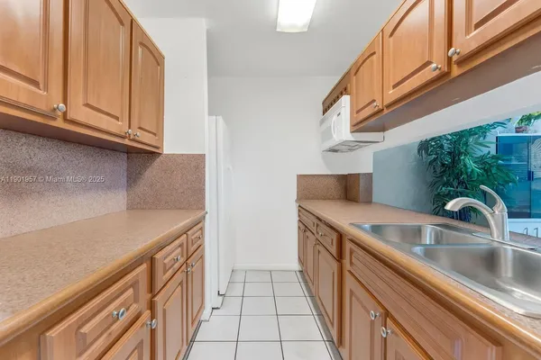 a kitchen with stainless steel appliances granite countertop a sink and a stove