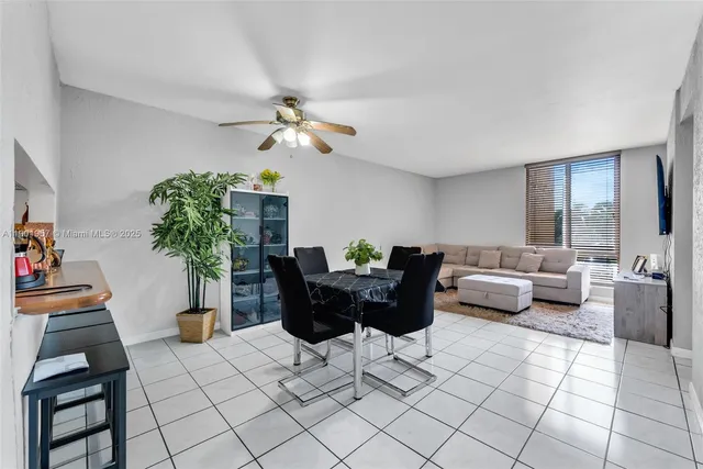 a living room with furniture a chandelier and a potted plant