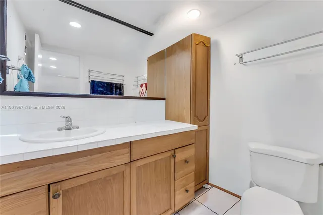 a bathroom with a sink a toilet and mirror