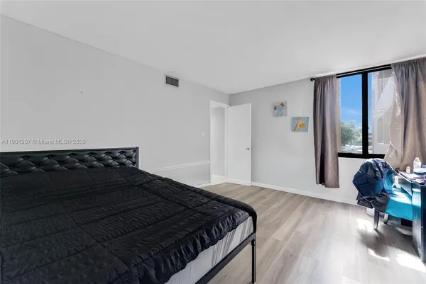 a bedroom with a bed window and a large window