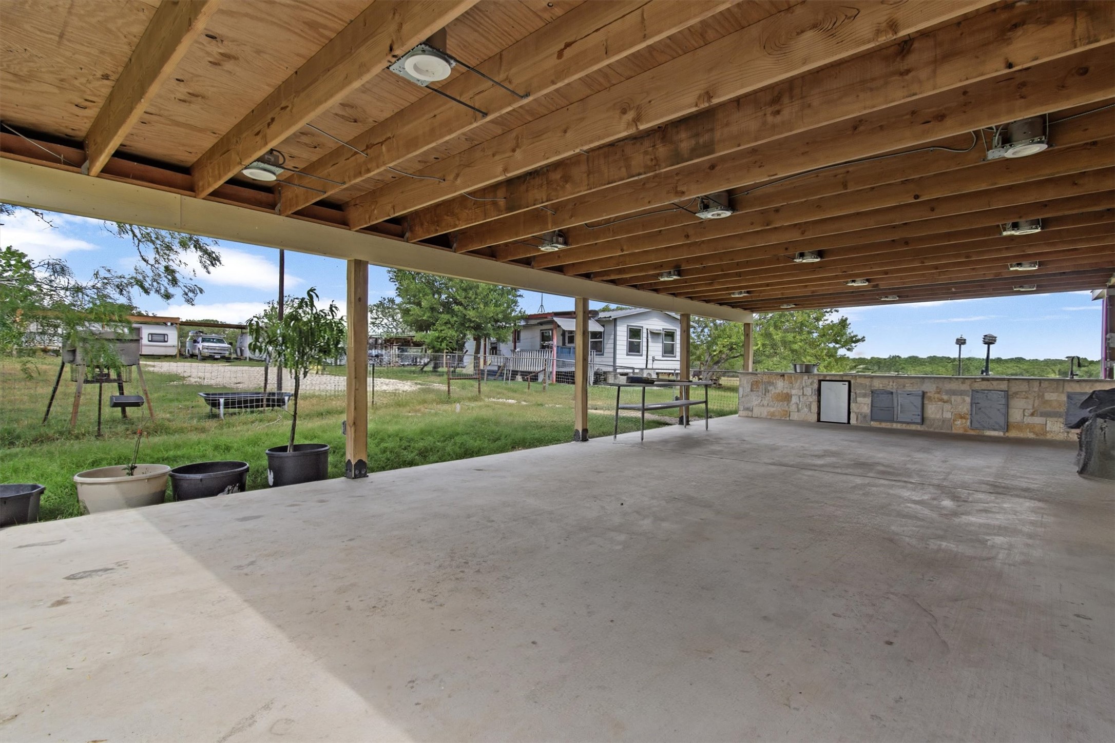 480 Grandpa Road Lockhart, TX 78644 - Photo 20 of 35 The centerpiece is a spacious ~2,061 sq ft manufactured home, just 1.5
years old, with 4 bedrooms, 2 bathrooms, and a beautifully crafted 40' x 20' stone outdoor kitchen under a covered
roof with lighting—ideal for hosting under the stars.