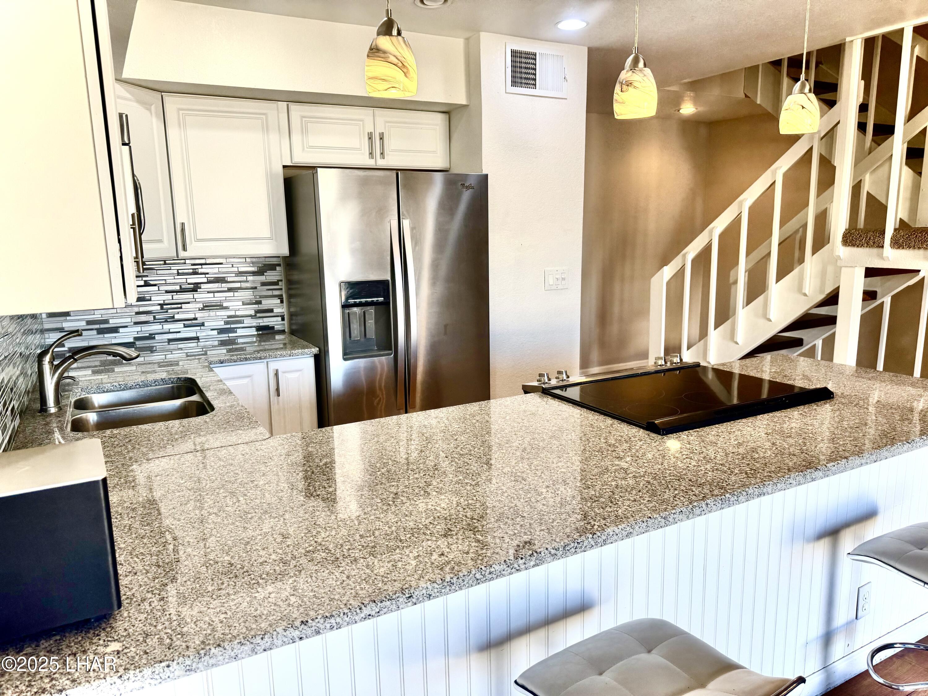 8625 Riverside Drive, Unit 38 Parker, AZ 85344 - Photo 11 of 48 a kitchen with stainless steel appliances granite countertop a sink refrigerator and microwave