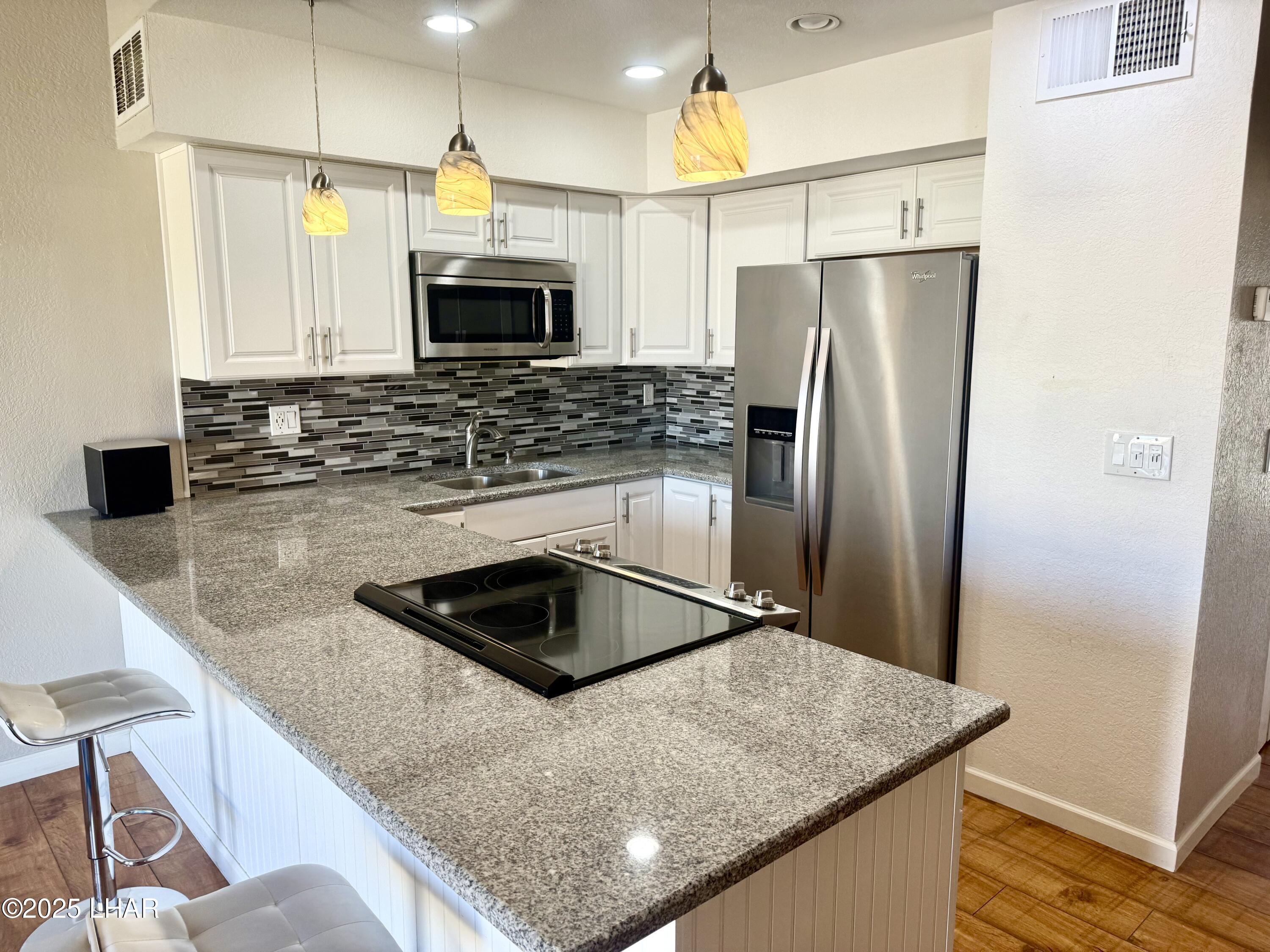 8625 Riverside Drive, Unit 38 Parker, AZ 85344 - Photo 13 of 48 a kitchen with kitchen island a counter top space cabinets and stainless steel appliances