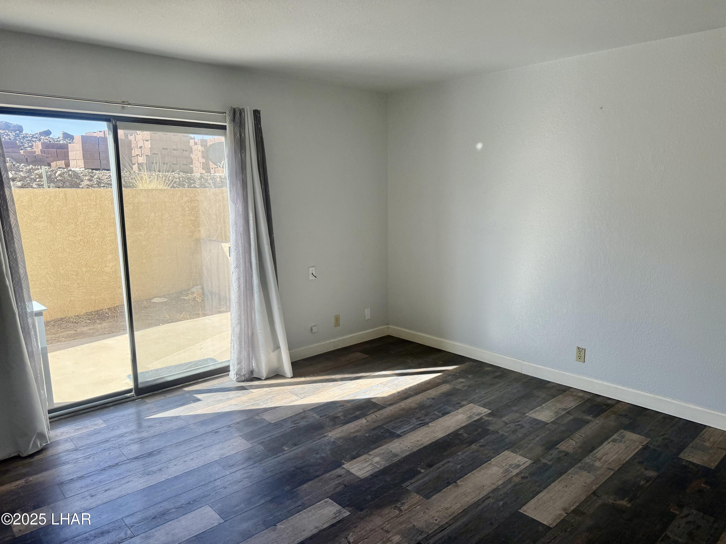 8625 Riverside Drive, Unit 38 Parker, AZ 85344 - Photo 18 of 48 an empty room with wooden floor and door