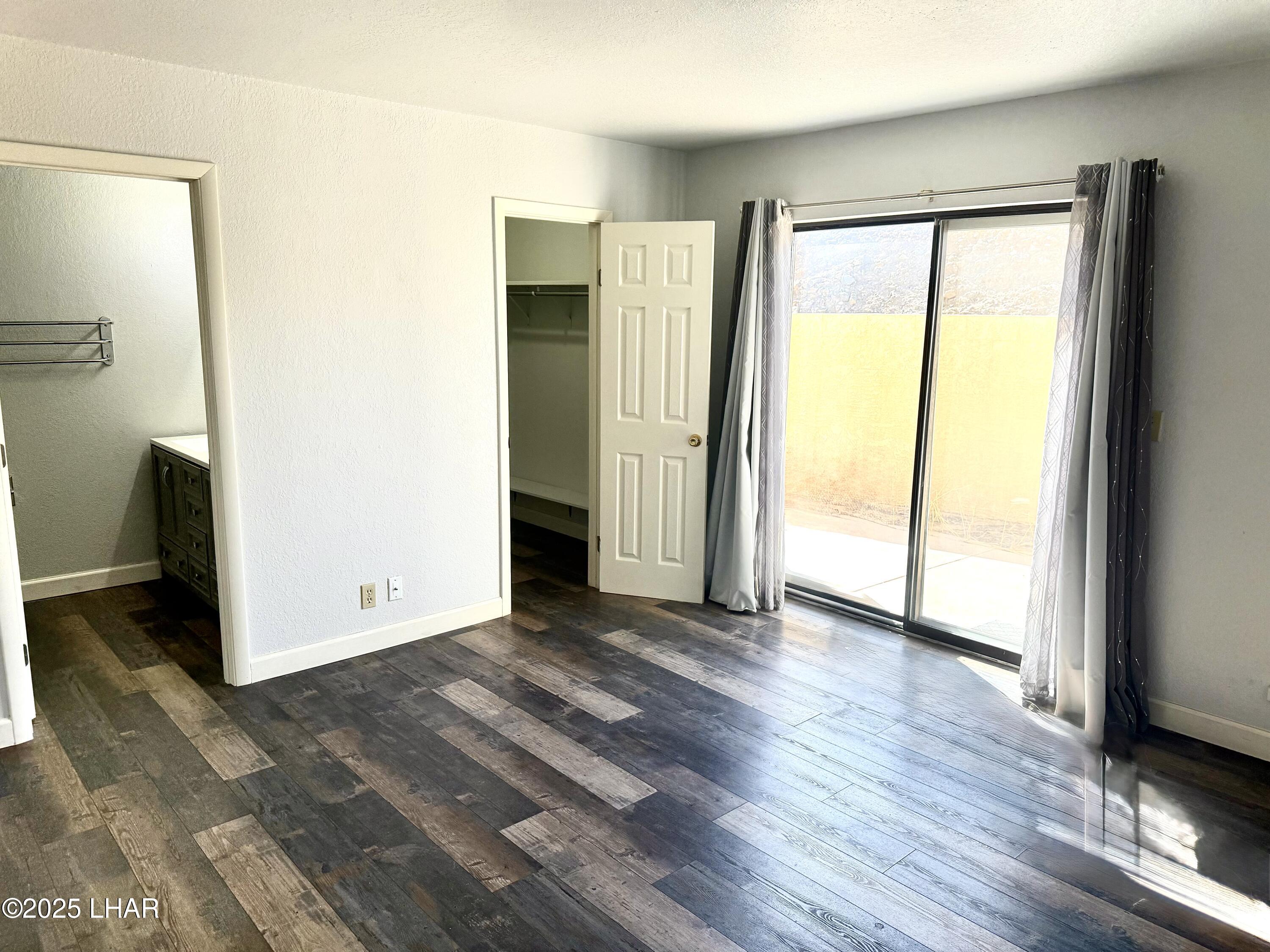 8625 Riverside Drive, Unit 38 Parker, AZ 85344 - Photo 19 of 48 an empty room with wooden floor and a window