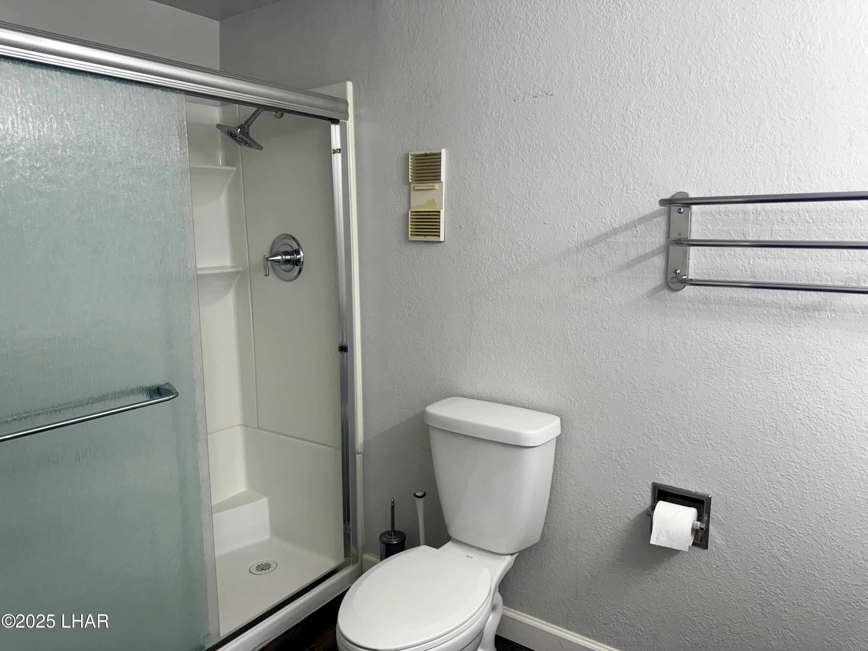 8625 Riverside Drive, Unit 38 Parker, AZ 85344 - Photo 23 of 48 a white toilet sitting next to a shower