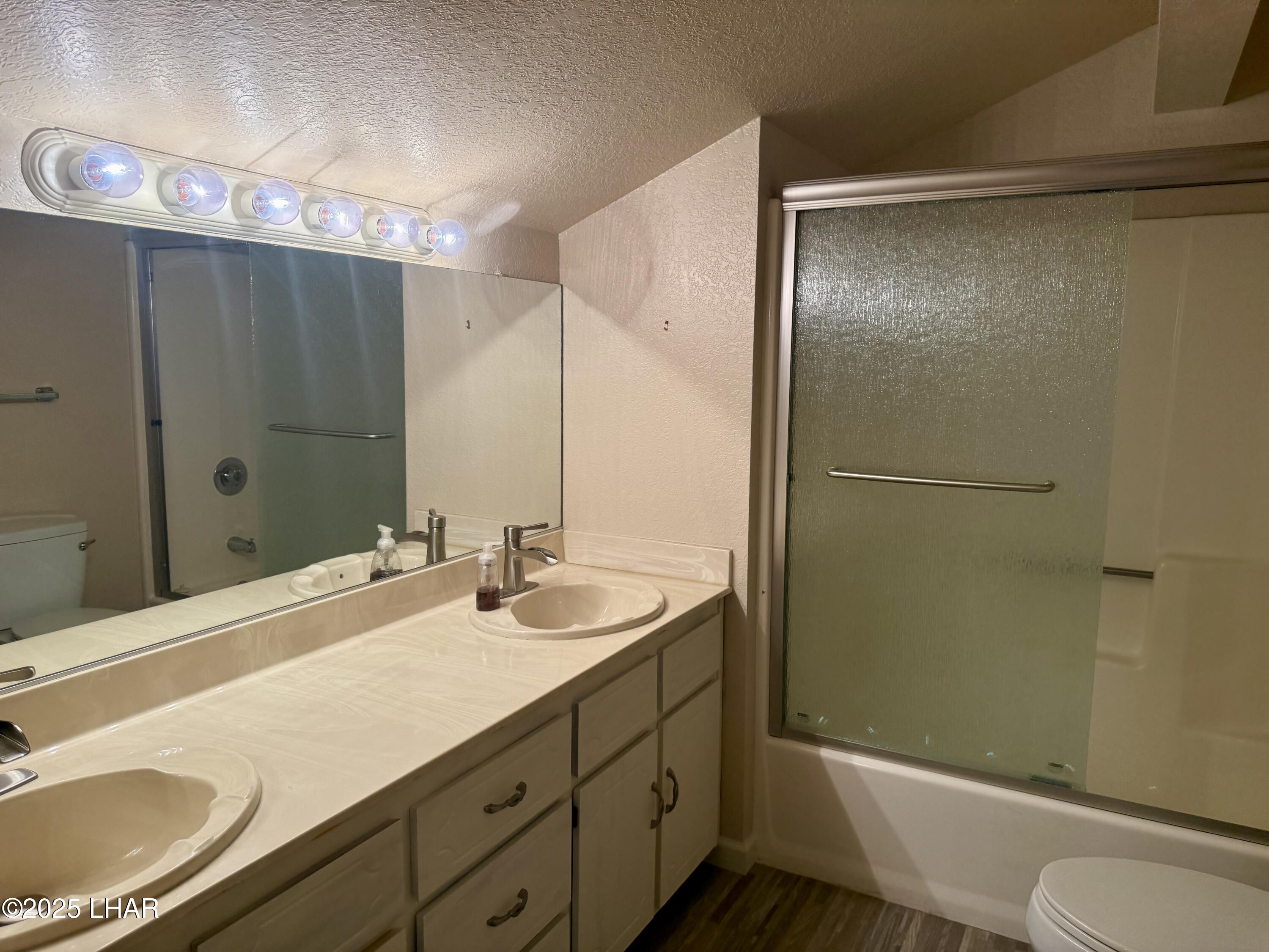 8625 Riverside Drive, Unit 38 Parker, AZ 85344 - Photo 29 of 48 a bathroom with a sink and mirror with toilet
