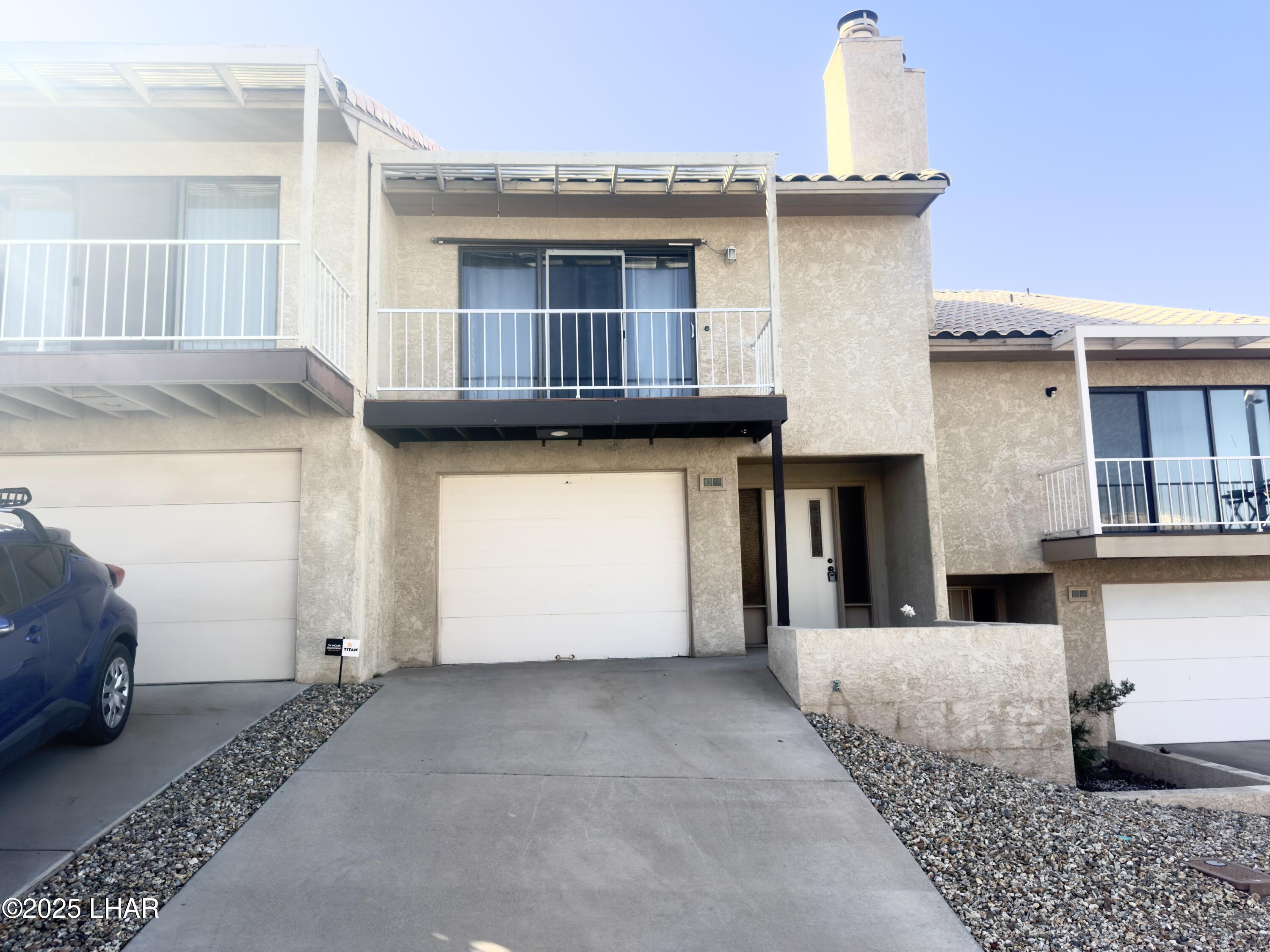 8625 Riverside Drive, Unit 38 Parker, AZ 85344 - Photo 3 of 48 a front view of a house with a garage