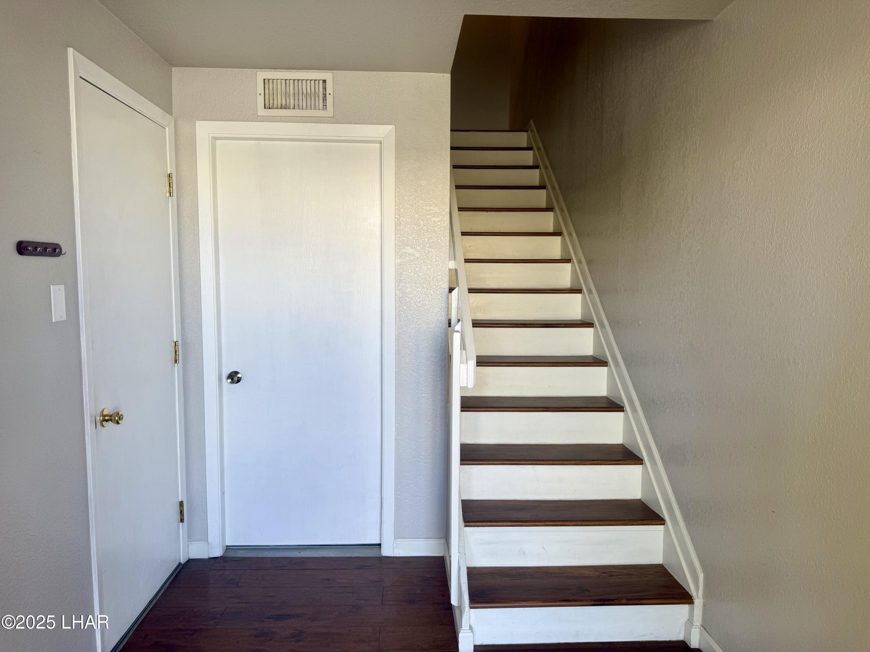 8625 Riverside Drive, Unit 38 Parker, AZ 85344 - Photo 4 of 48 a view of a hallway with wooden floor and white walls