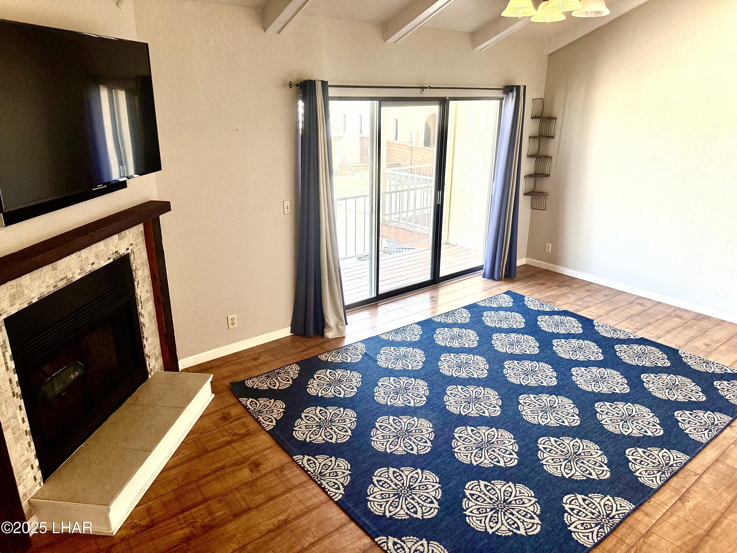 8625 Riverside Drive, Unit 38 Parker, AZ 85344 - Photo 8 of 48 a bedroom with a bed and a flat tv screen next to a window