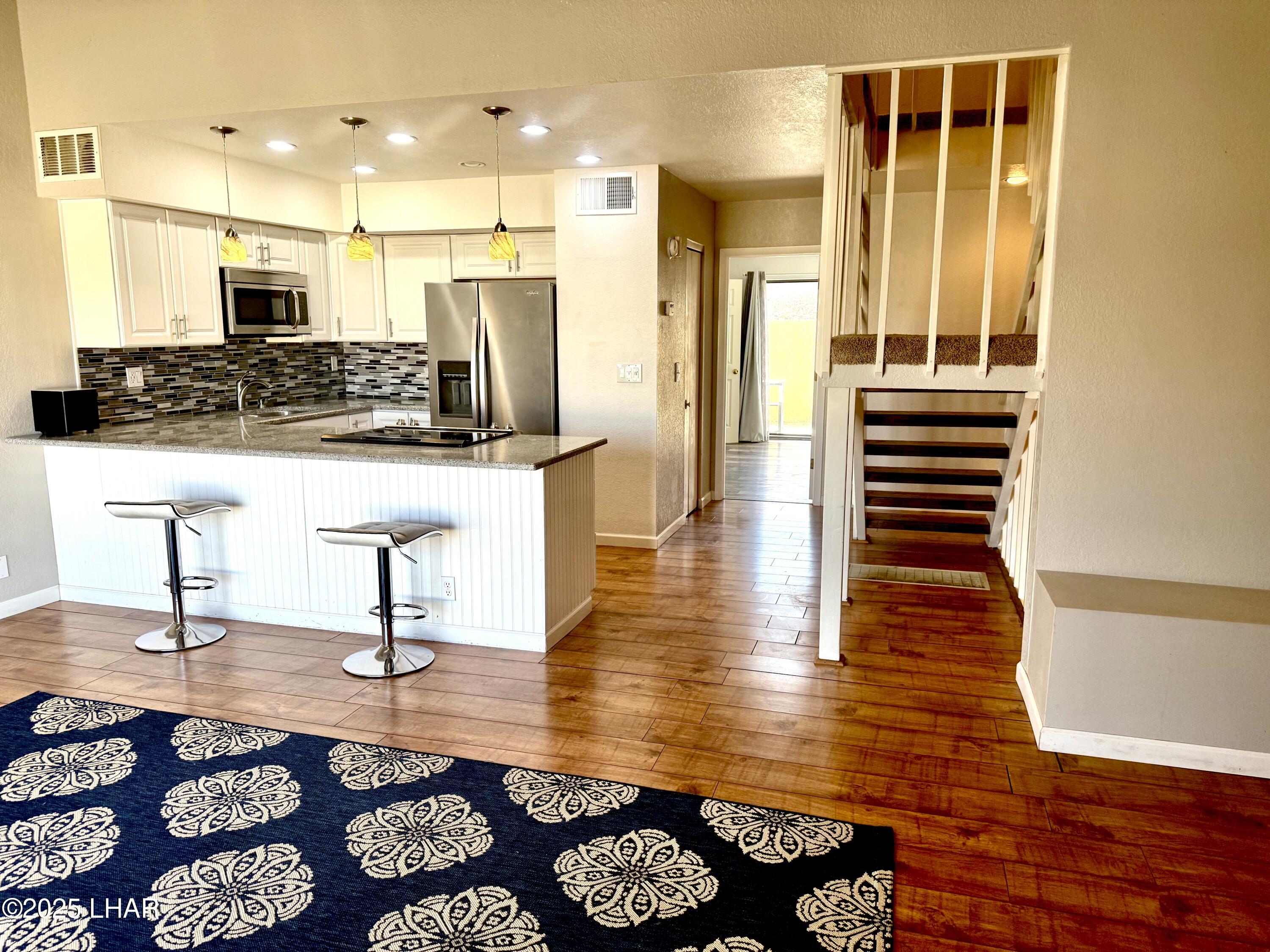 8625 Riverside Drive, Unit 38 Parker, AZ 85344 - Photo 9 of 48 a room with lots of wooden furniture and a rug
