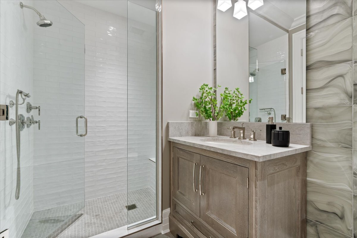 9 West Walton Street, Unit 702 Chicago, IL 60610 - Photo 28 of 38 a bathroom with a sink and mirror