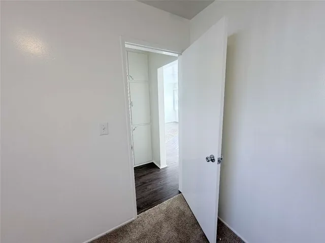 a view of wooden floor and windows in a room