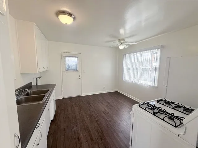 a kitchen that has a sink stainless steel appliances a counter space and a window