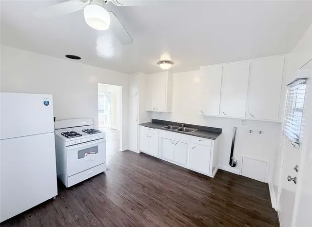 a kitchen with granite countertop a stove and a refrigerator