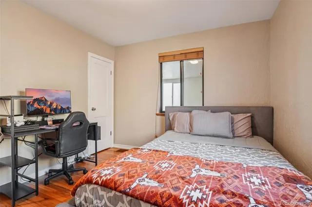 a bedroom with a large bed and a desk