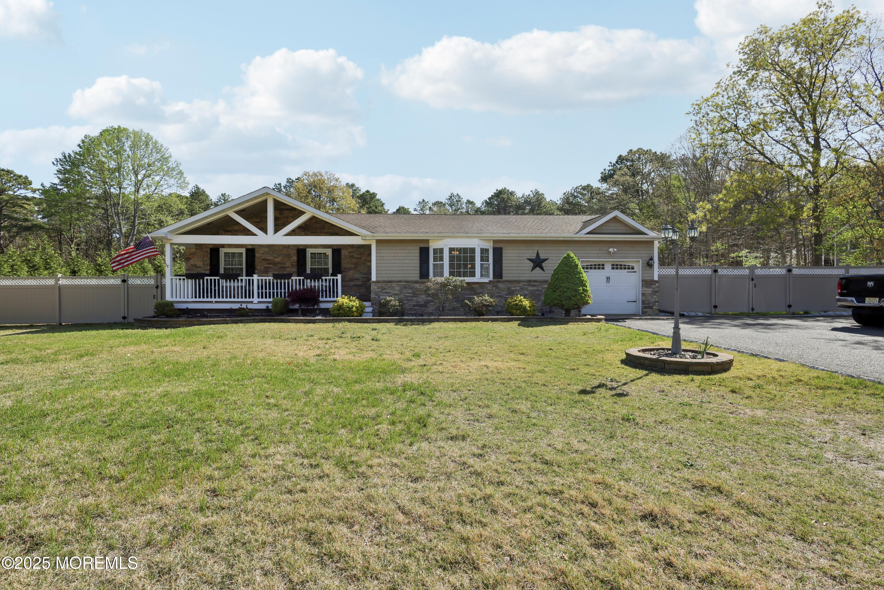 a front view of a house with a yard and green space