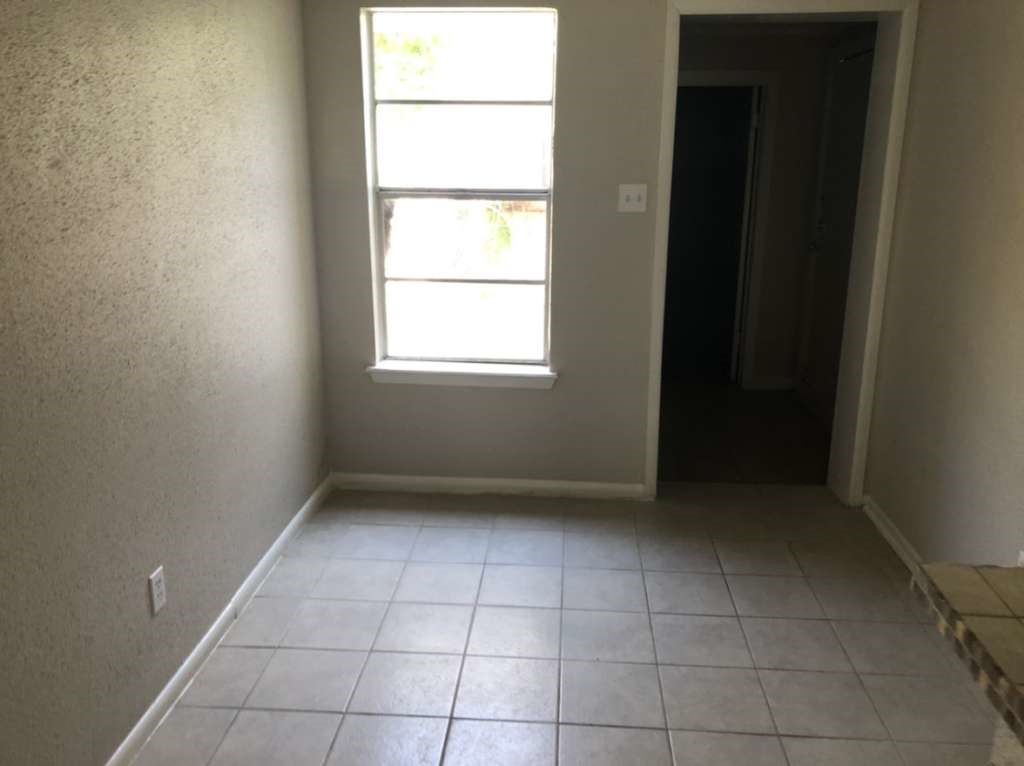 811 Buchta Road, Unit C Angleton, TX 77515 - Photo 7 of 10 a view of an empty room with a window