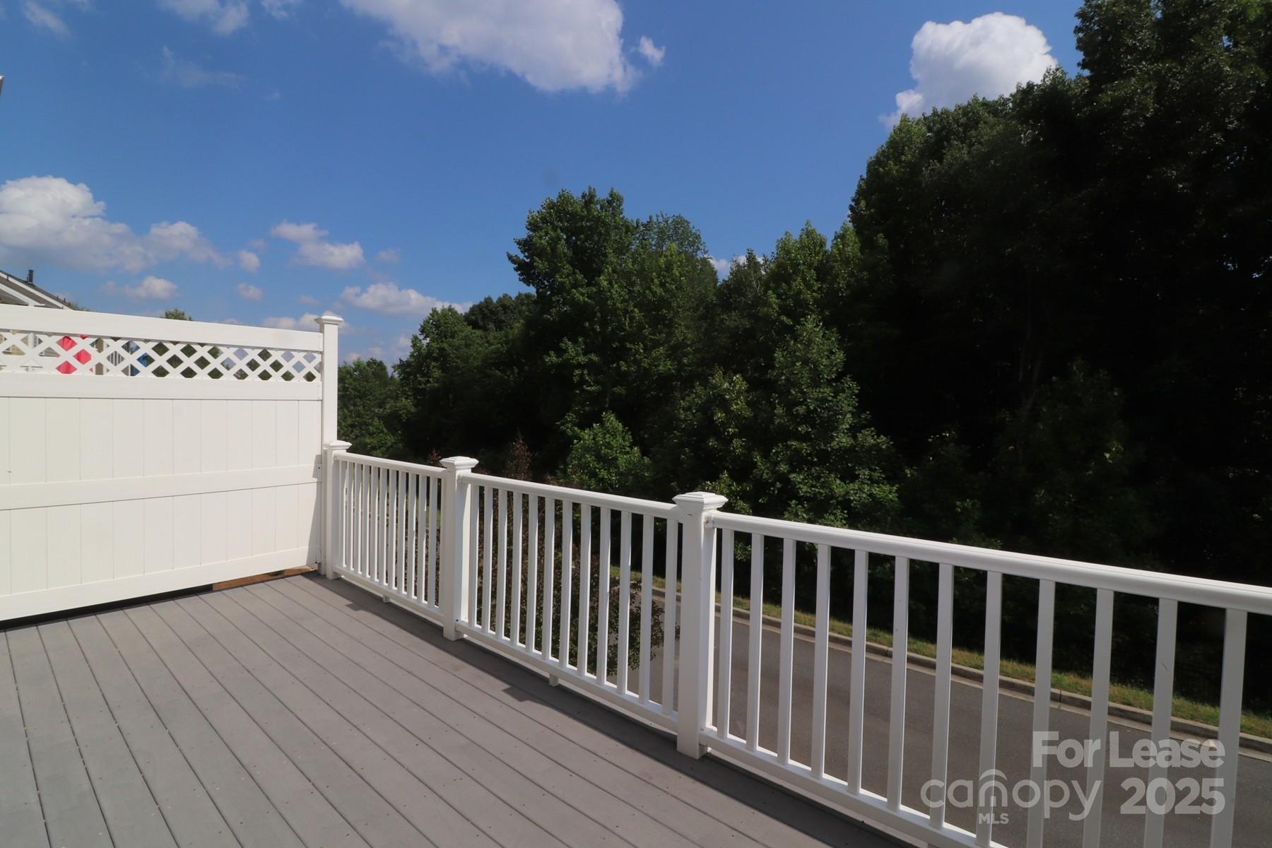 564 6th Baxter Crossing Fort Mill, SC 29708 - Photo 17 of 31 a view of a roof deck with wooden floor and fence