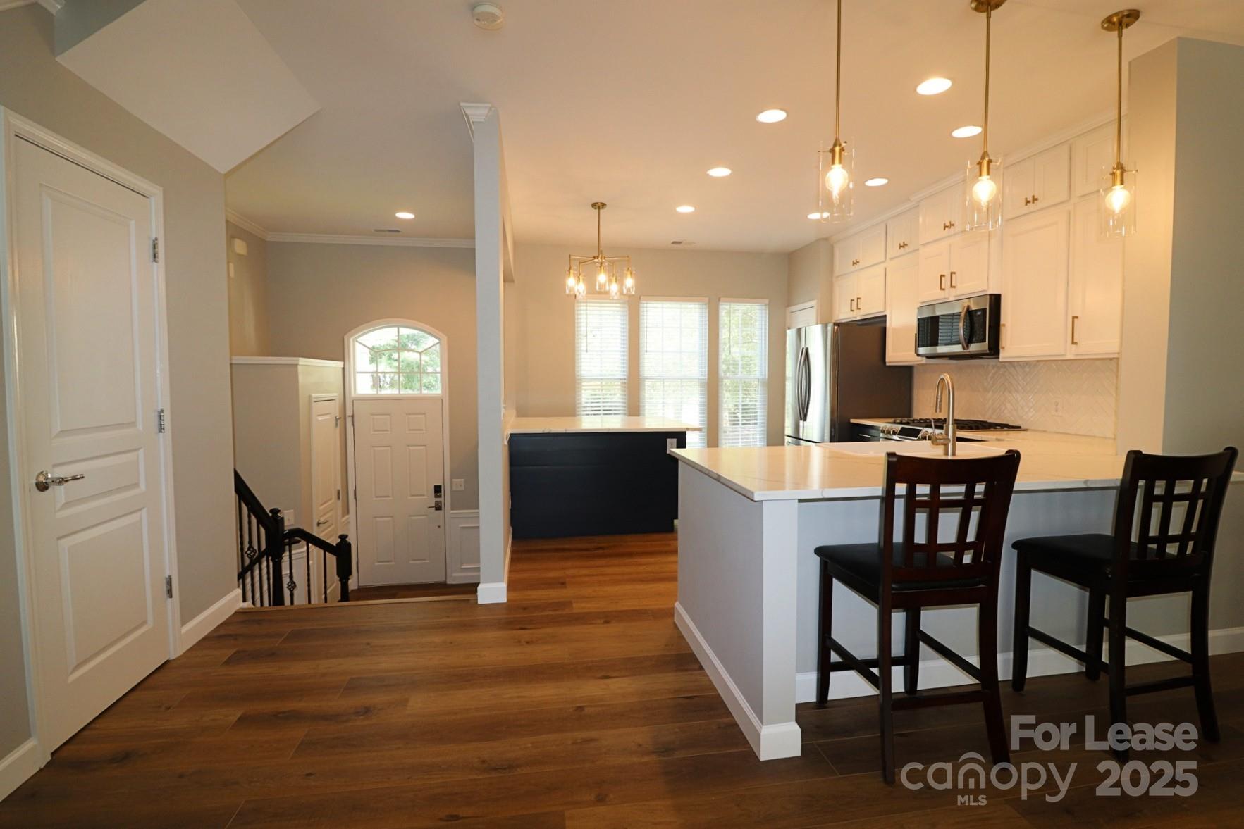564 6th Baxter Crossing Fort Mill, SC 29708 - Photo 5 of 31 a view of a dining room with furniture and wooden floor