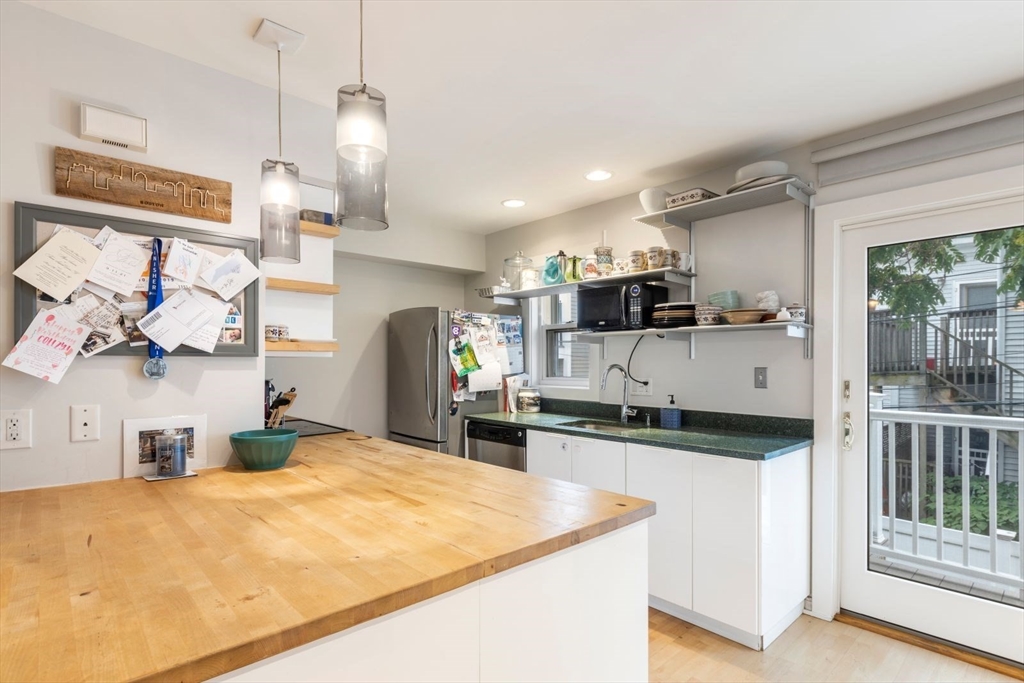 63 Bolton Street, Unit 63 Boston, MA 02127 - Photo 11 of 29 a kitchen with stainless steel appliances granite countertop a sink and a stove