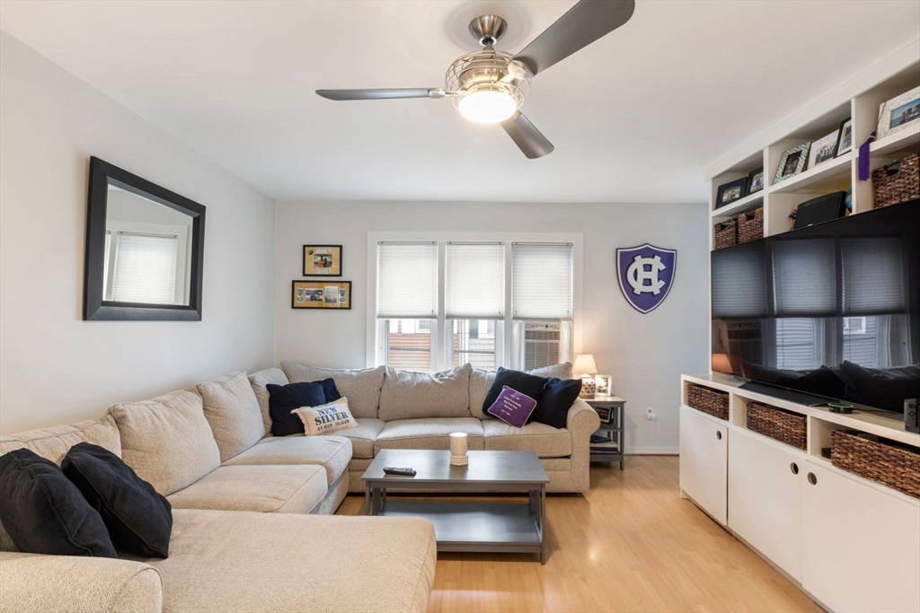63 Bolton Street, Unit 63 Boston, MA 02127 - Photo 2 of 29 a living room with furniture and a flat screen tv