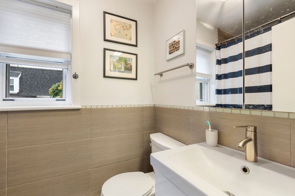 63 Bolton Street, Unit 63 Boston, MA 02127 - Photo 21 of 29 a bathroom with a toilet sink and mirror