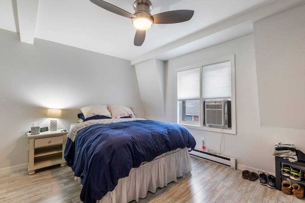 63 Bolton Street, Unit 63 Boston, MA 02127 - Photo 22 of 29 a bedroom with a bed and a window