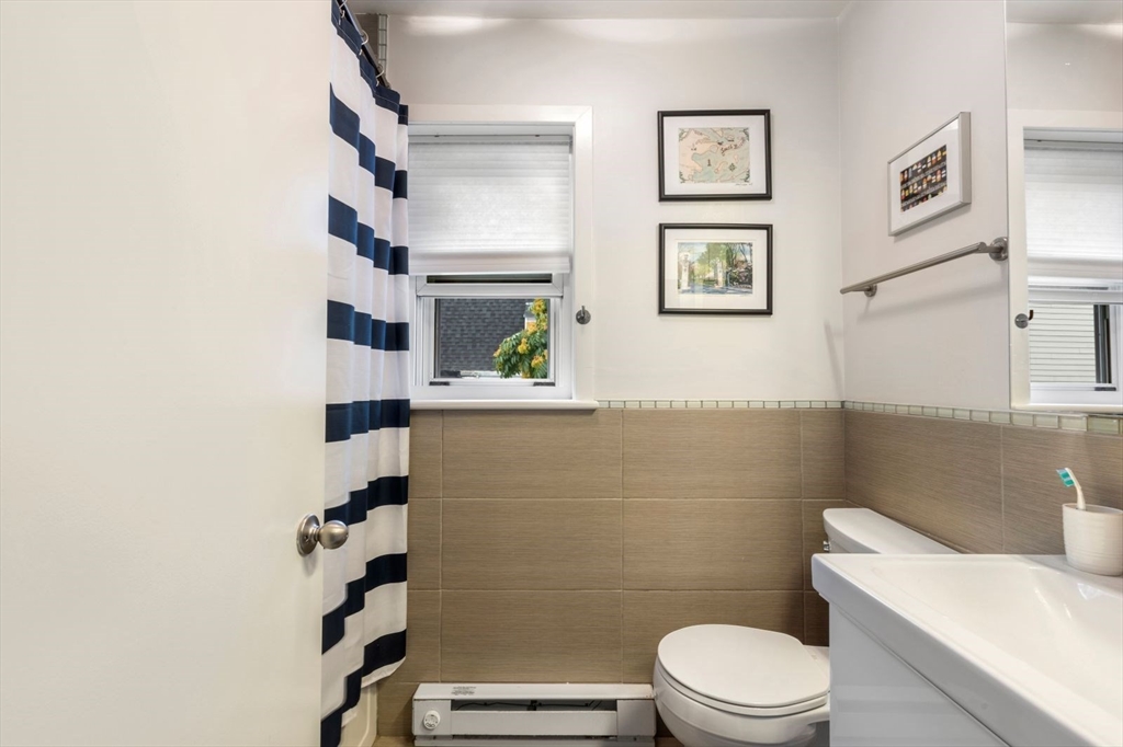 63 Bolton Street, Unit 63 Boston, MA 02127 - Photo 23 of 29 a bathroom with a toilet and a shower curtain