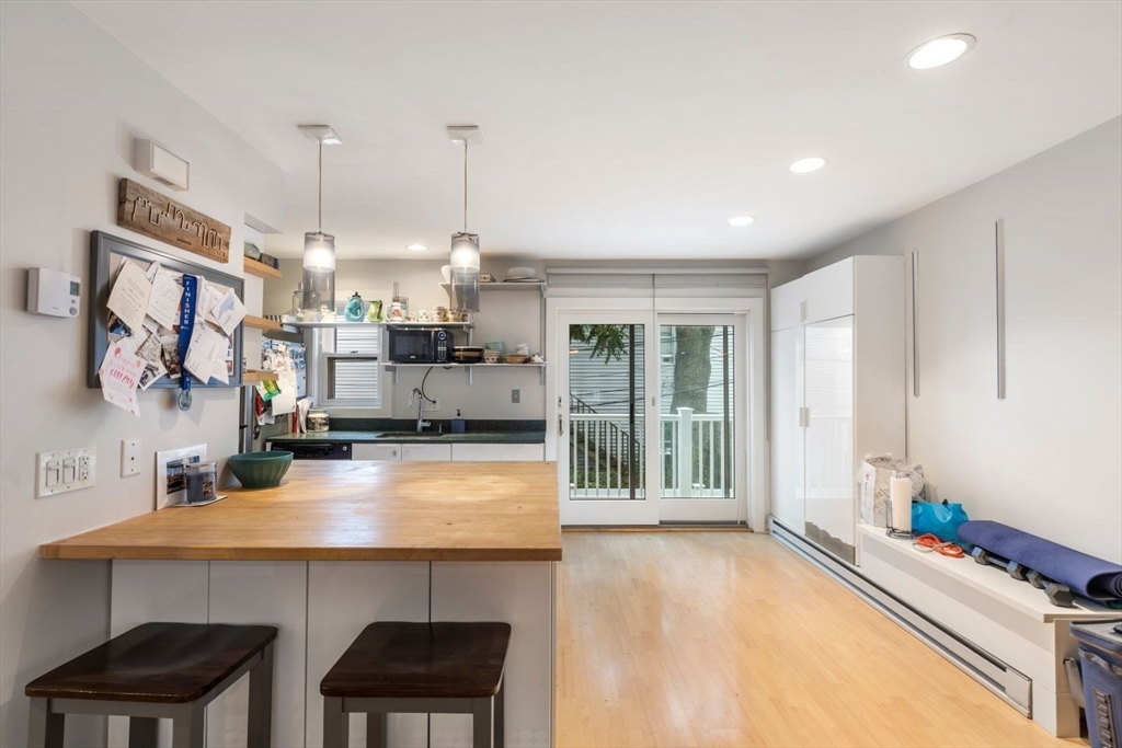 63 Bolton Street, Unit 63 Boston, MA 02127 - Photo 3 of 29 a kitchen with stainless steel appliances a sink stove and a refrigerator
