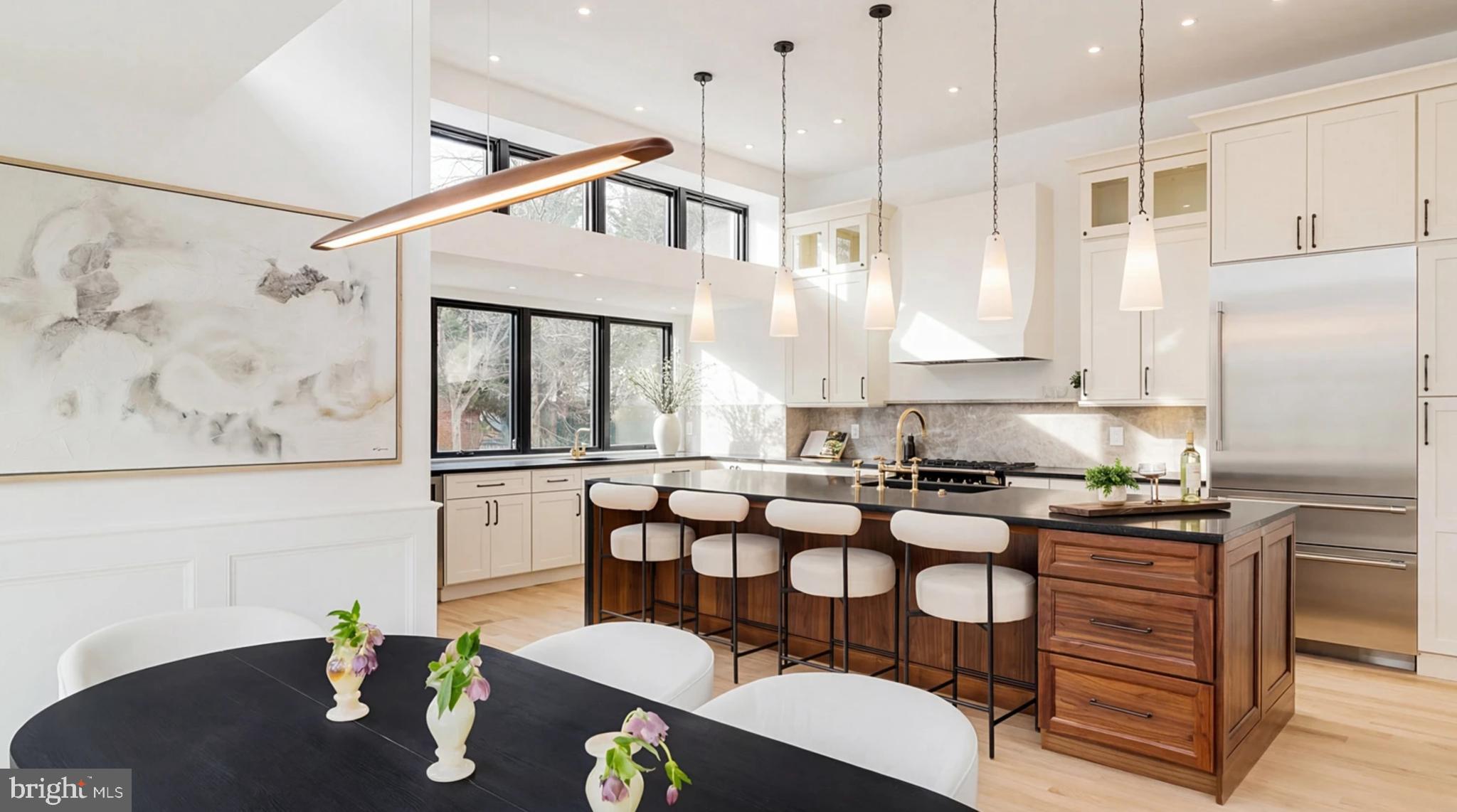 a kitchen with granite countertop a table chairs stove and wooden floor