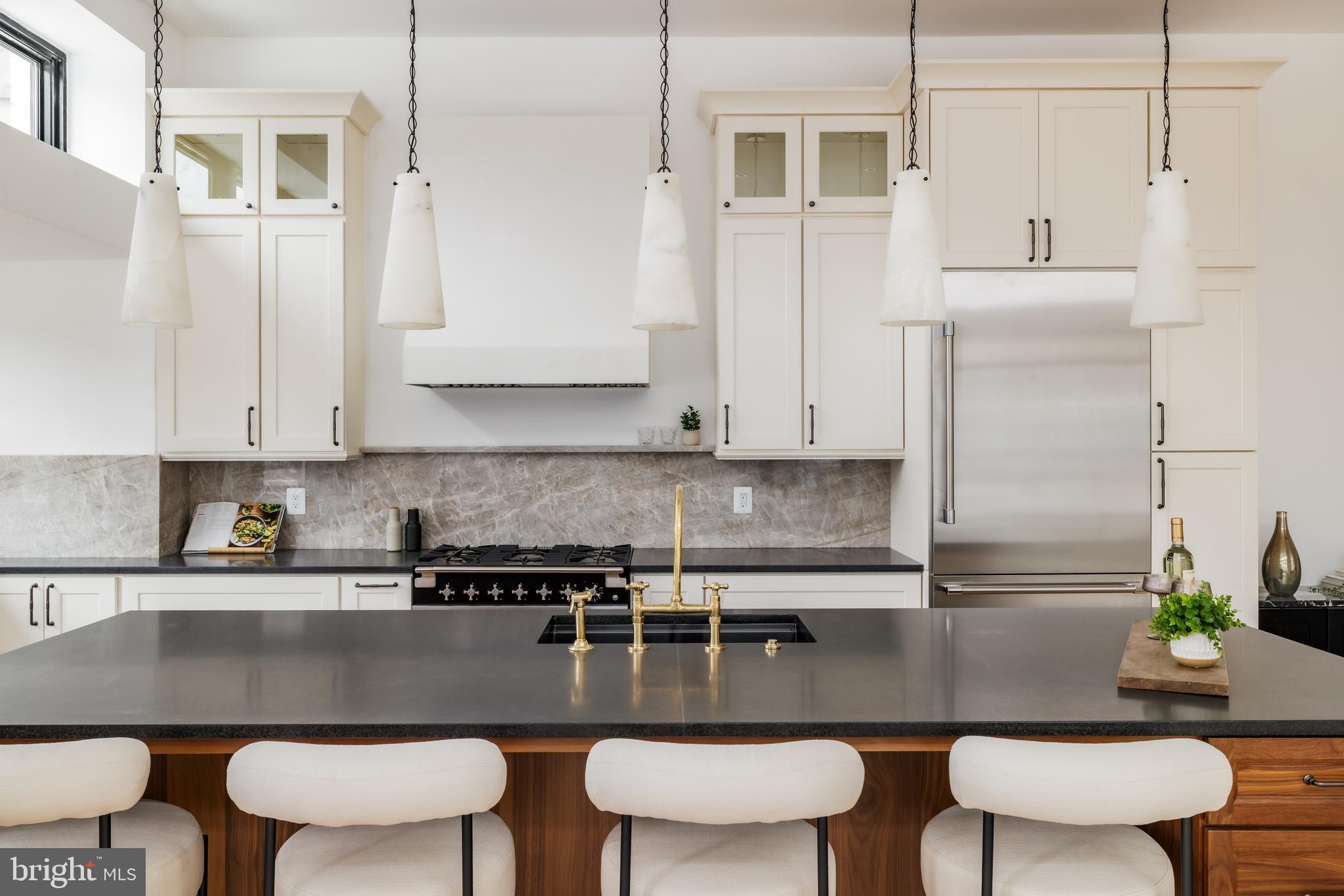 304 N Street Northwest, Unit 1 Washington, DC 20001 - Photo 14 of 47 a kitchen with a table chairs stove and cabinets