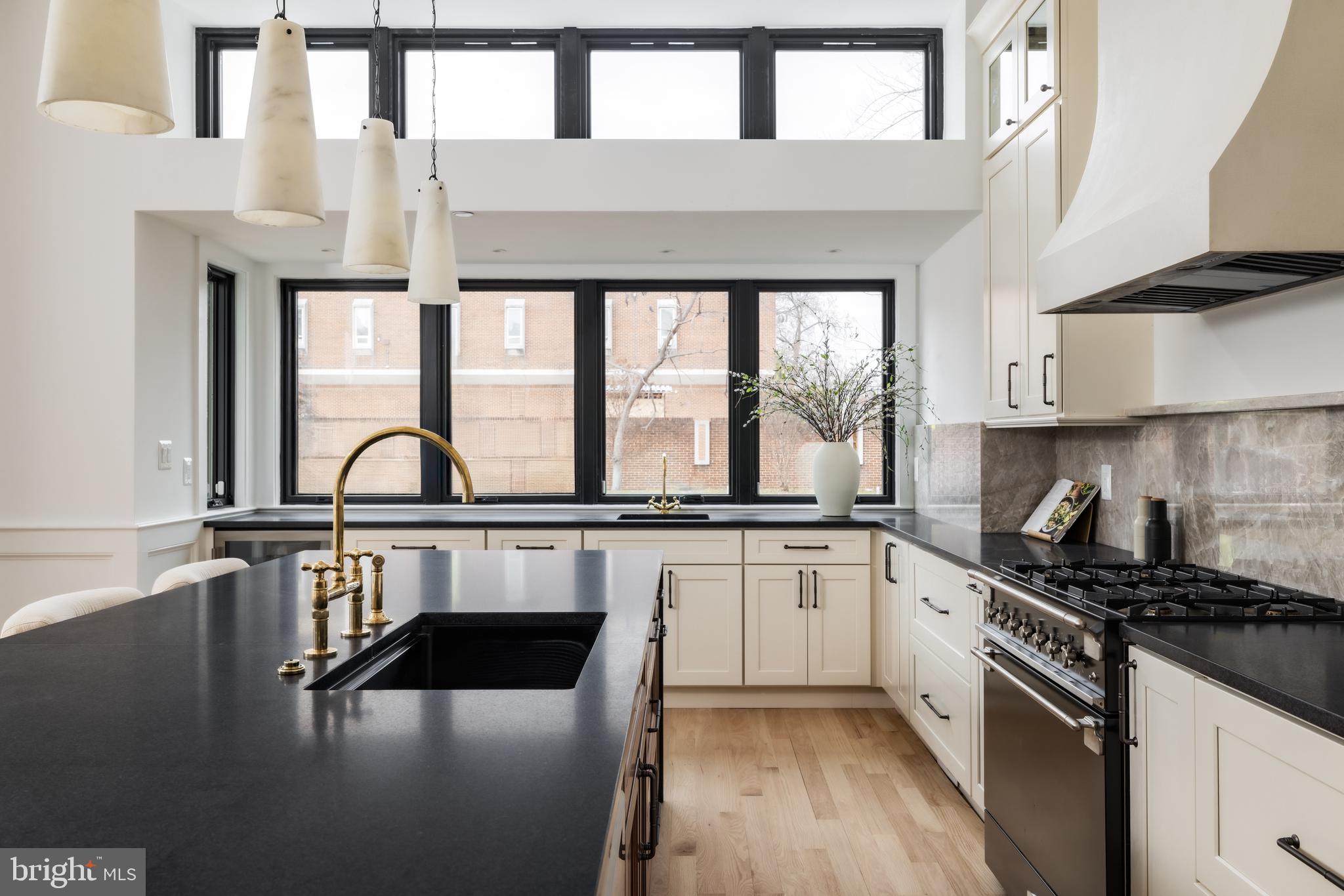 304 N Street Northwest, Unit 1 Washington, DC 20001 - Photo 17 of 47 a kitchen with stainless steel appliances granite countertop a stove a sink and cabinets