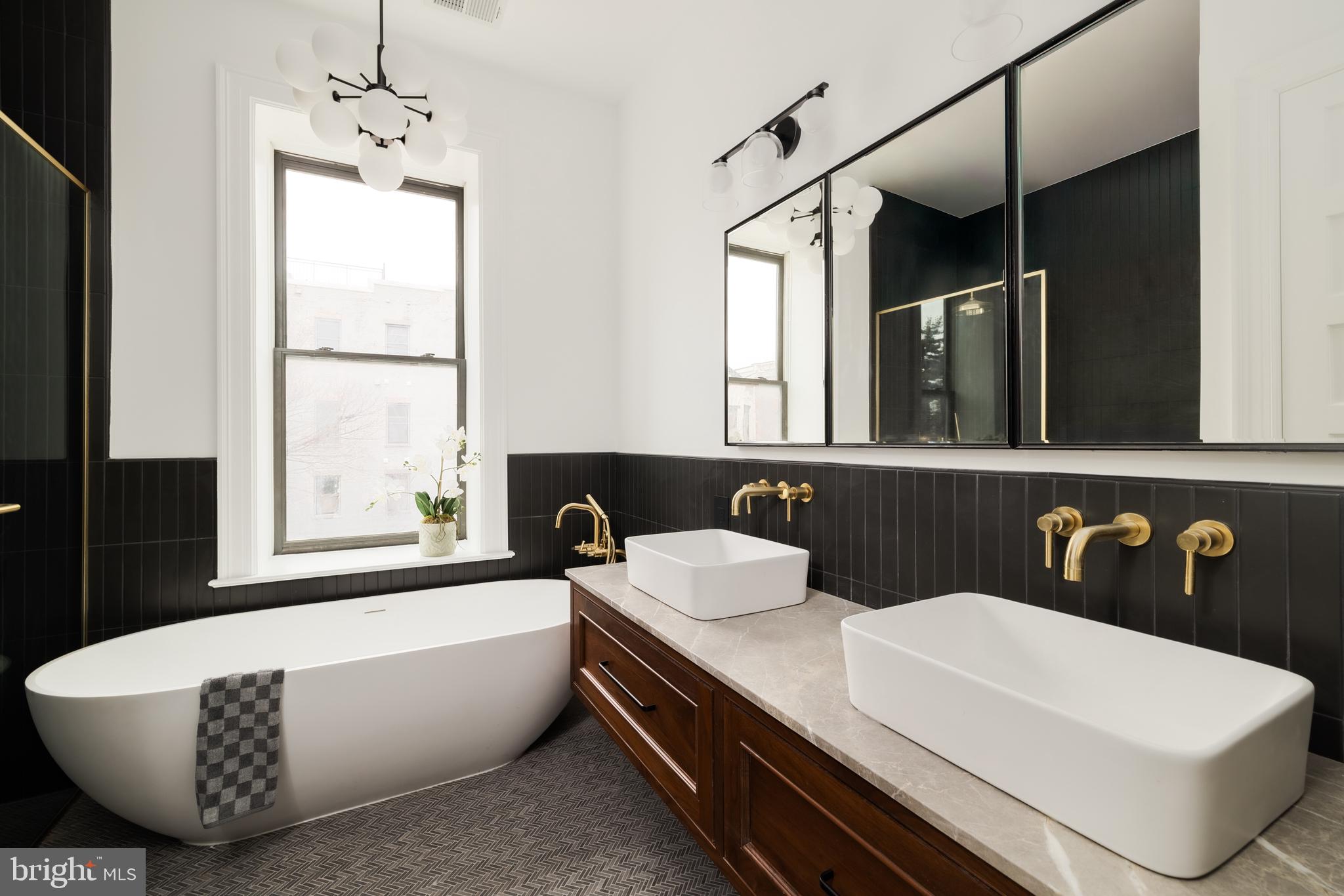304 N Street Northwest, Unit 1 Washington, DC 20001 - Photo 26 of 47 a bathroom with a sink a bathtub and a mirror