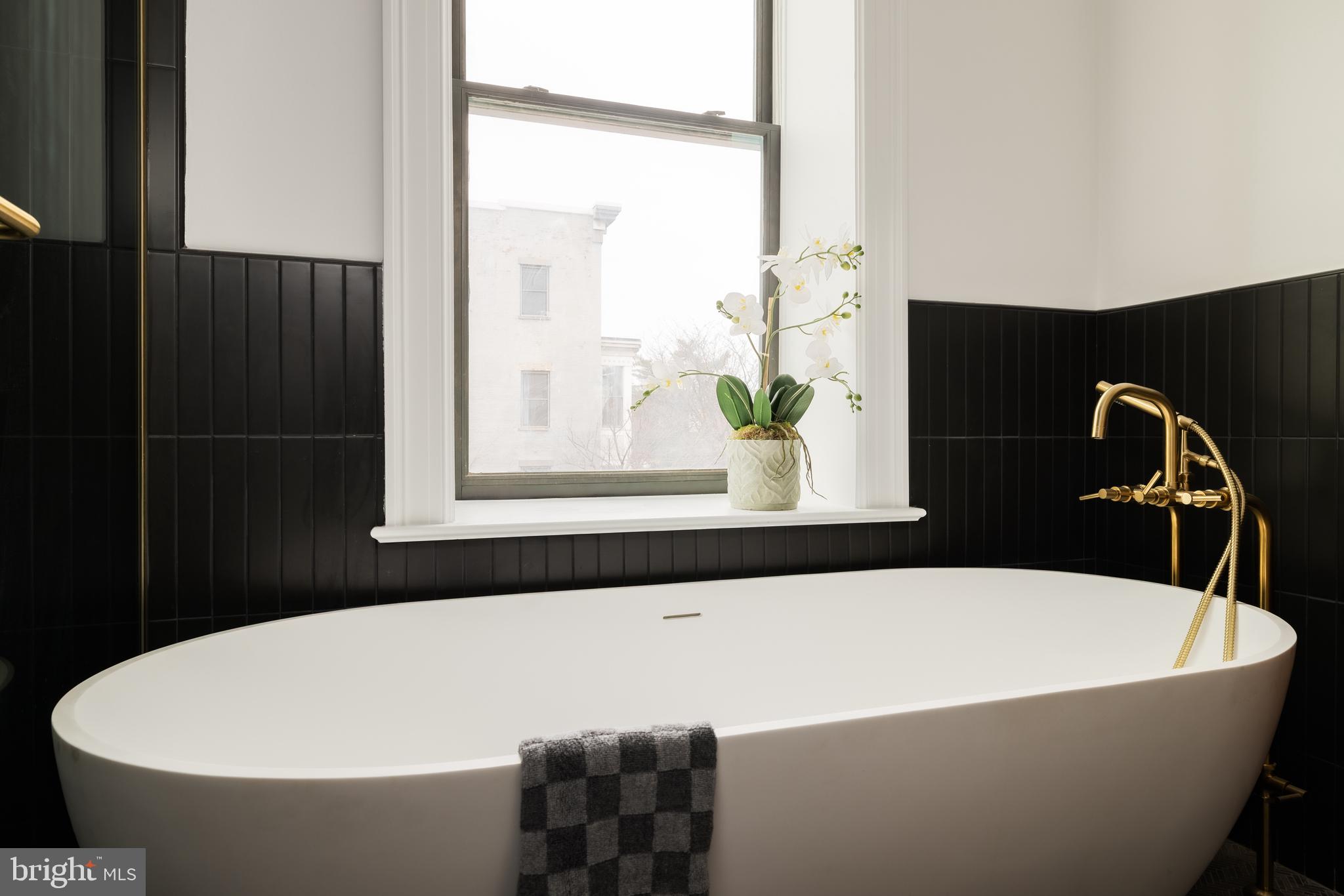 304 N Street Northwest, Unit 1 Washington, DC 20001 - Photo 29 of 47 a white bath tub sitting in a bathroom next to a window