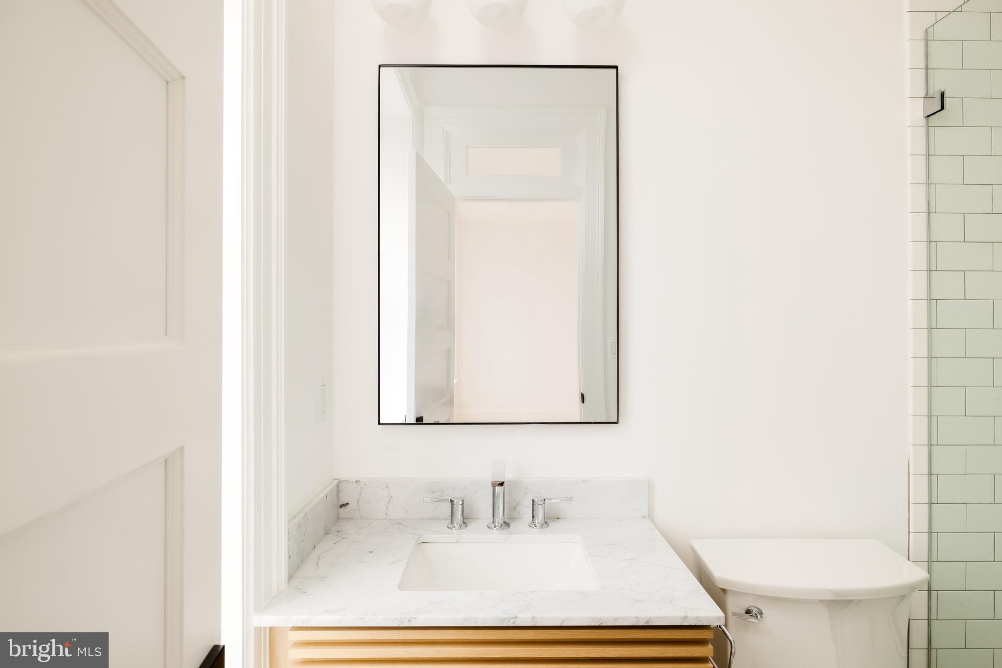 304 N Street Northwest, Unit 1 Washington, DC 20001 - Photo 35 of 47 a bathroom with a sink toilet and vanity