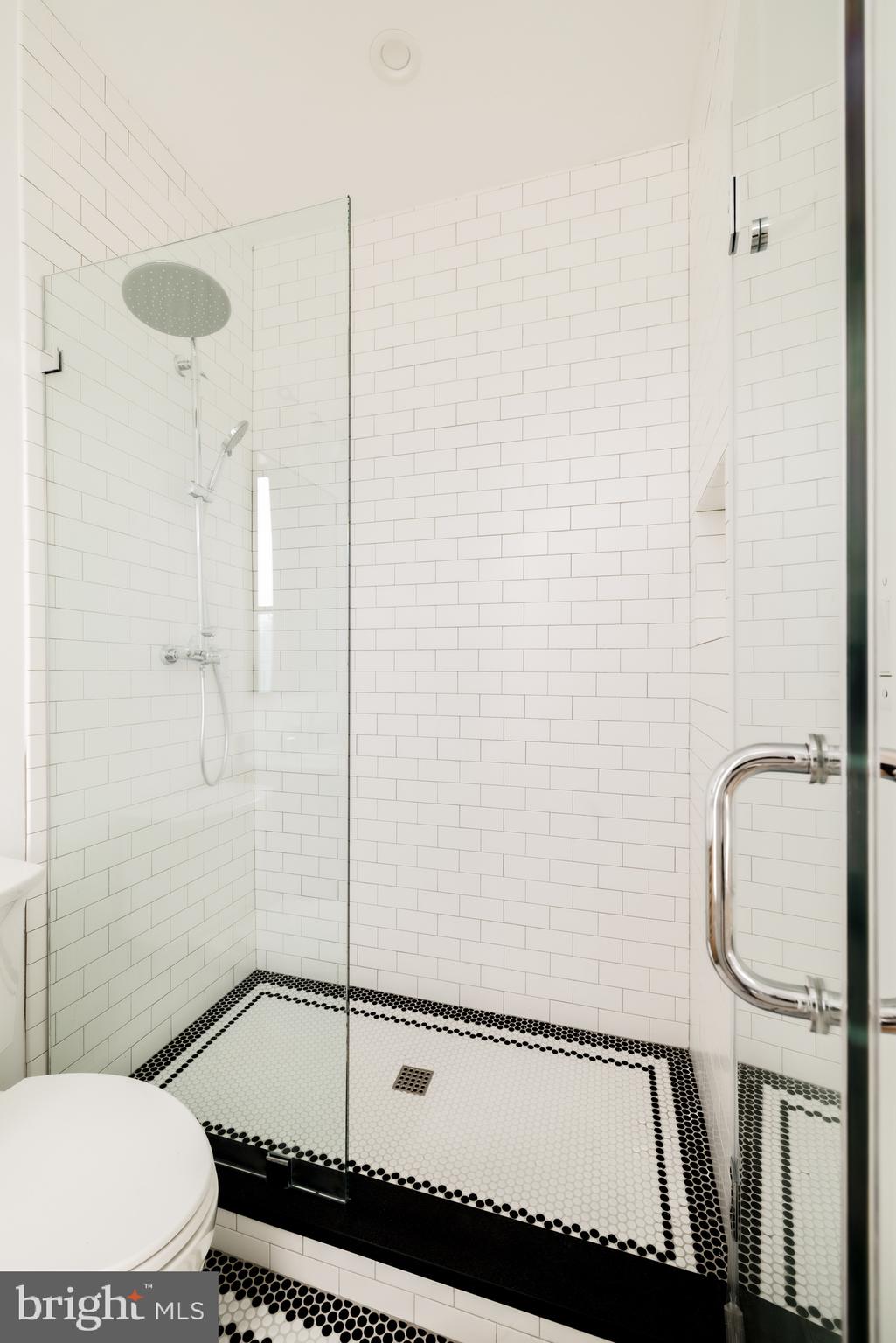 304 N Street Northwest, Unit 1 Washington, DC 20001 - Photo 36 of 47 a bathroom with a granite countertop bathtub and a shower