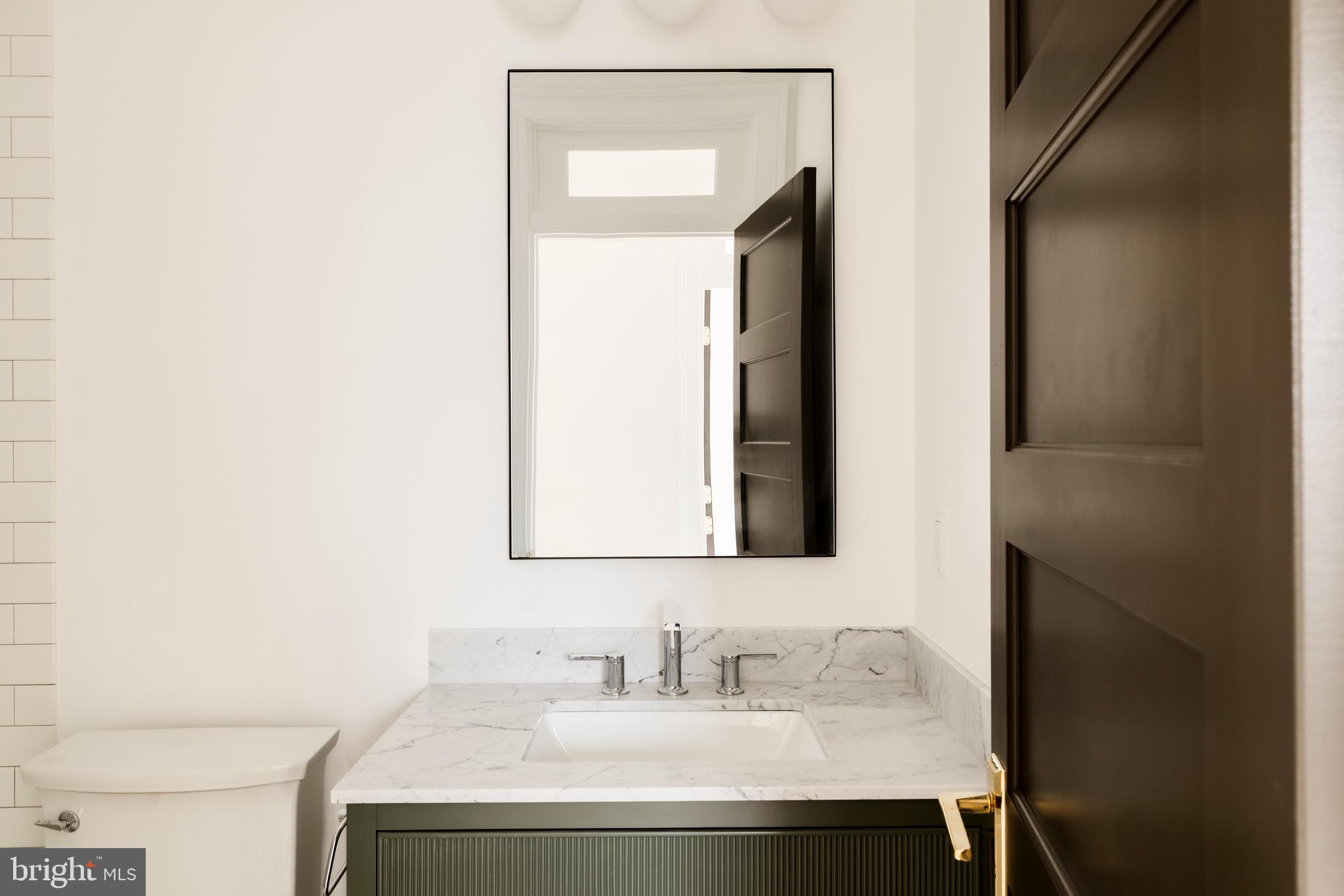 304 N Street Northwest, Unit 1 Washington, DC 20001 - Photo 37 of 47 a bathroom with a sink and a mirror