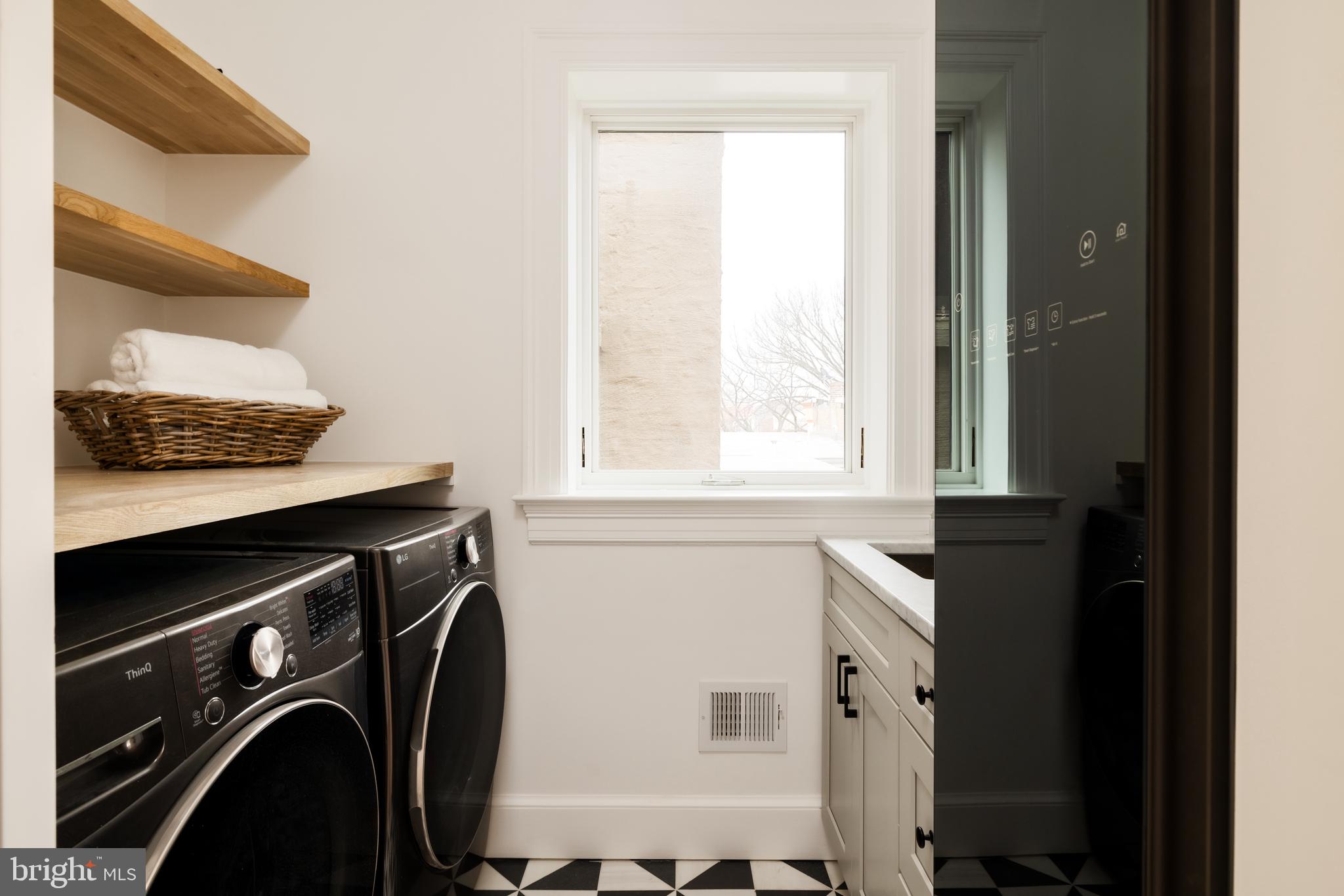 304 N Street Northwest, Unit 1 Washington, DC 20001 - Photo 39 of 47 a utility room with dryer and washer