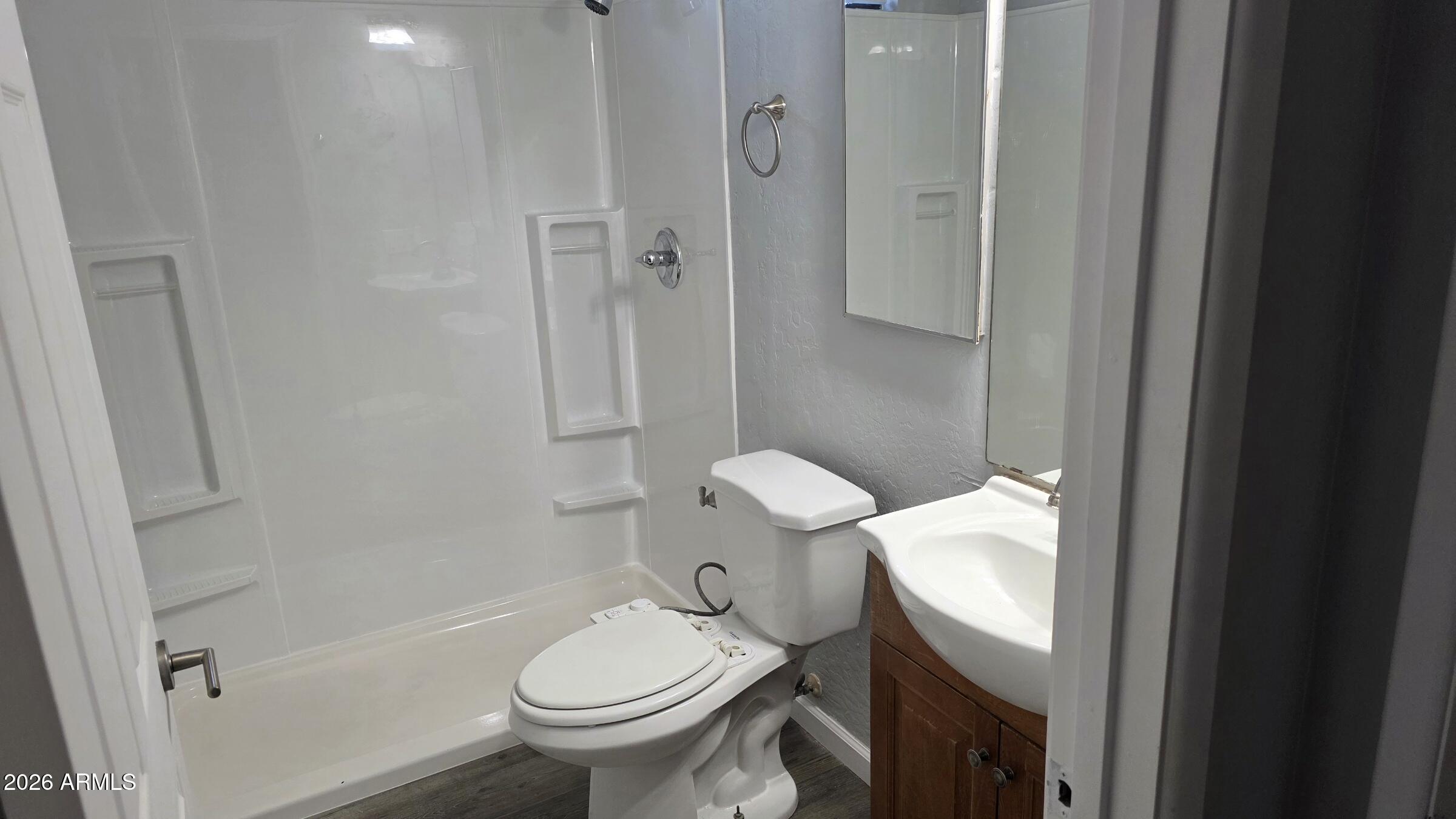 1287 North Alma School Road, Unit 282 Chandler, AZ 85224 - Photo 12 of 18 a bathroom with a granite countertop toilet and a shower
