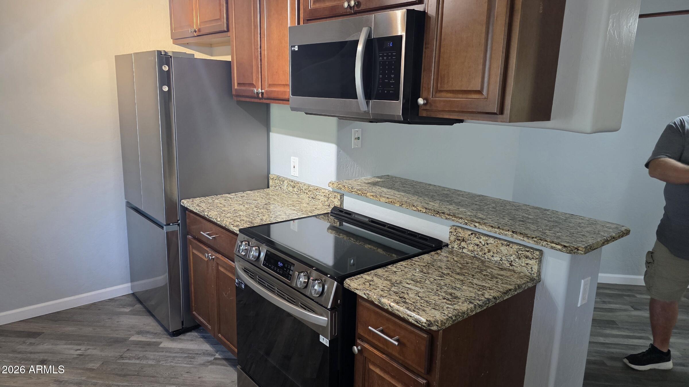 1287 North Alma School Road, Unit 282 Chandler, AZ 85224 - Photo 6 of 18 a kitchen with stainless steel appliances granite countertop a sink and a refrigerator
