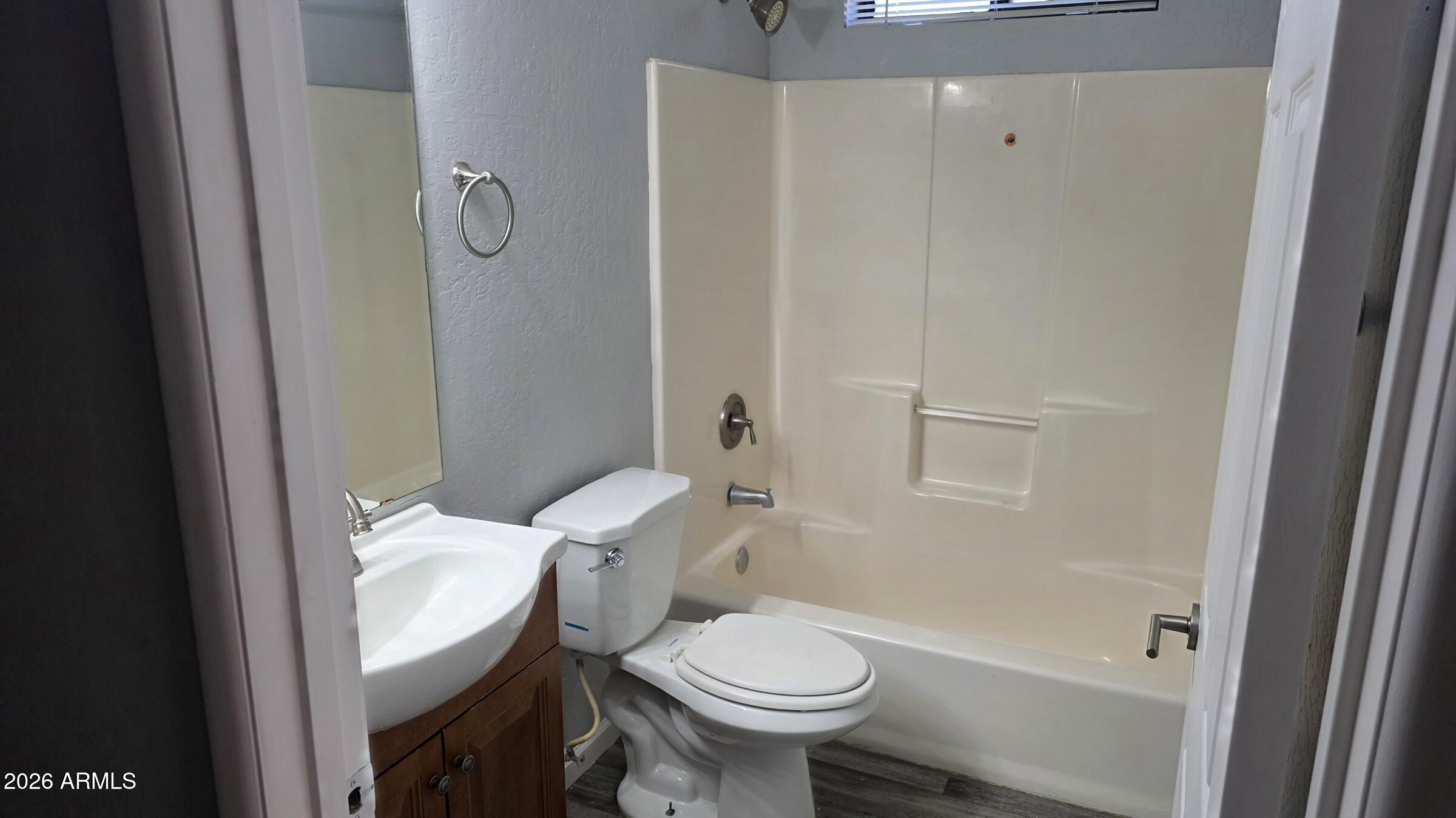 1287 North Alma School Road, Unit 282 Chandler, AZ 85224 - Photo 9 of 18 a bathroom with a granite countertop toilet and a shower