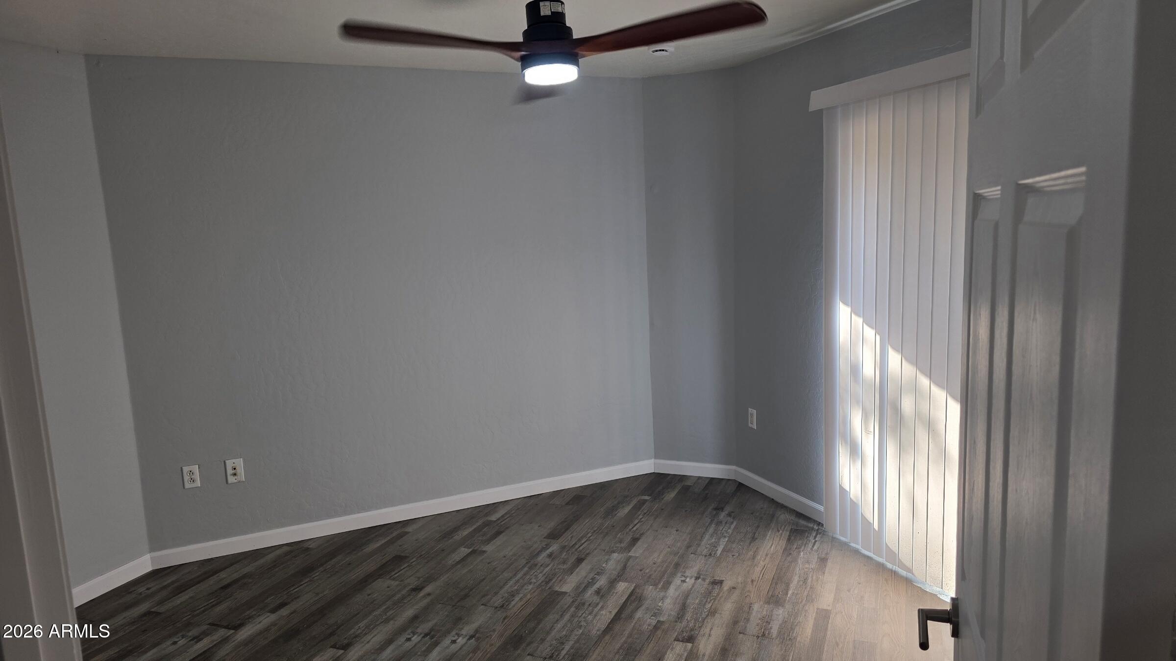 1287 North Alma School Road, Unit 282 Chandler, AZ 85224 - Photo 10 of 18 an empty room with wooden floor and windows