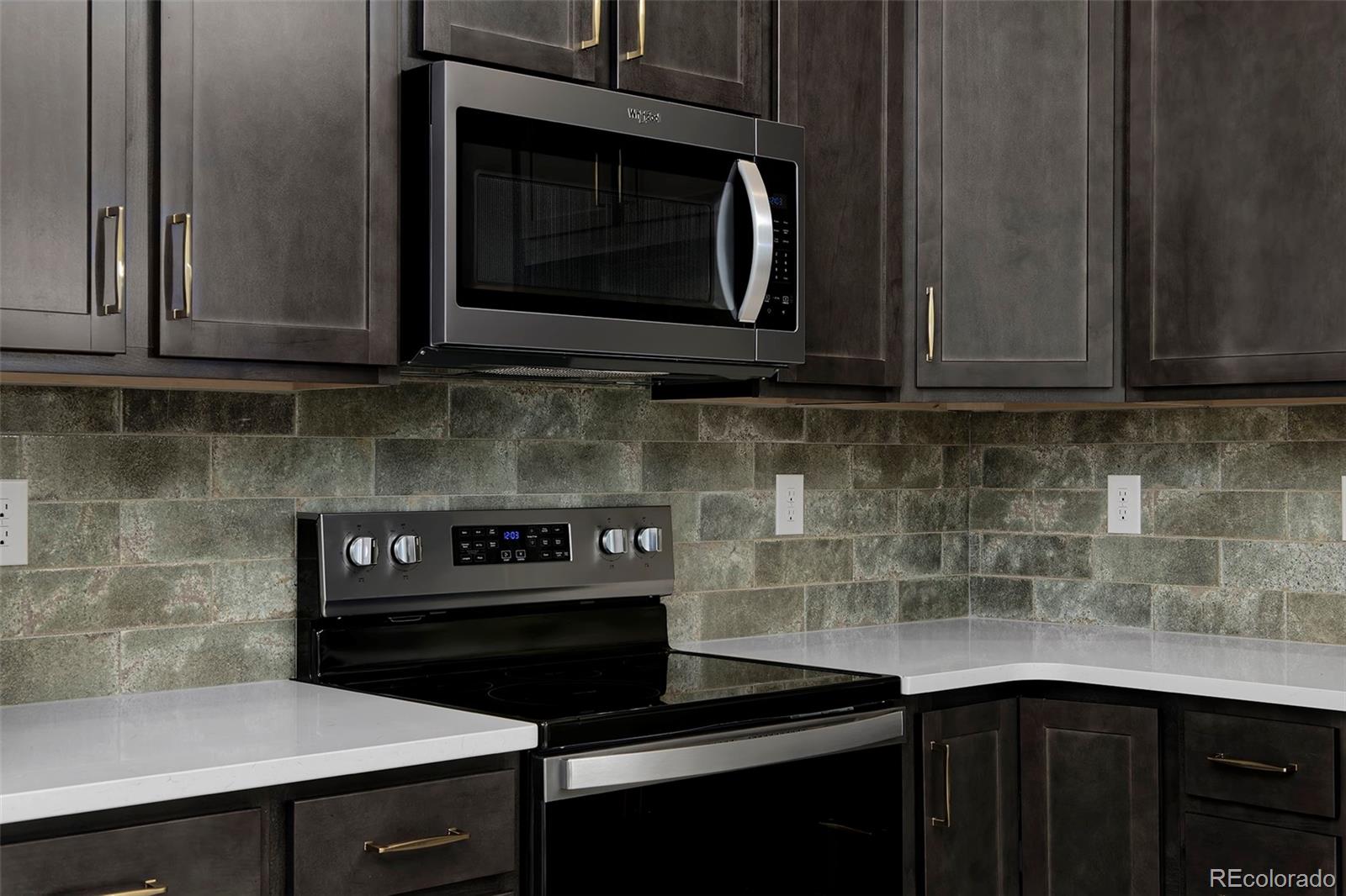 3136 West Bonfils Place Denver, CO 80236 - Photo 17 of 43 a kitchen with a stove and a microwave