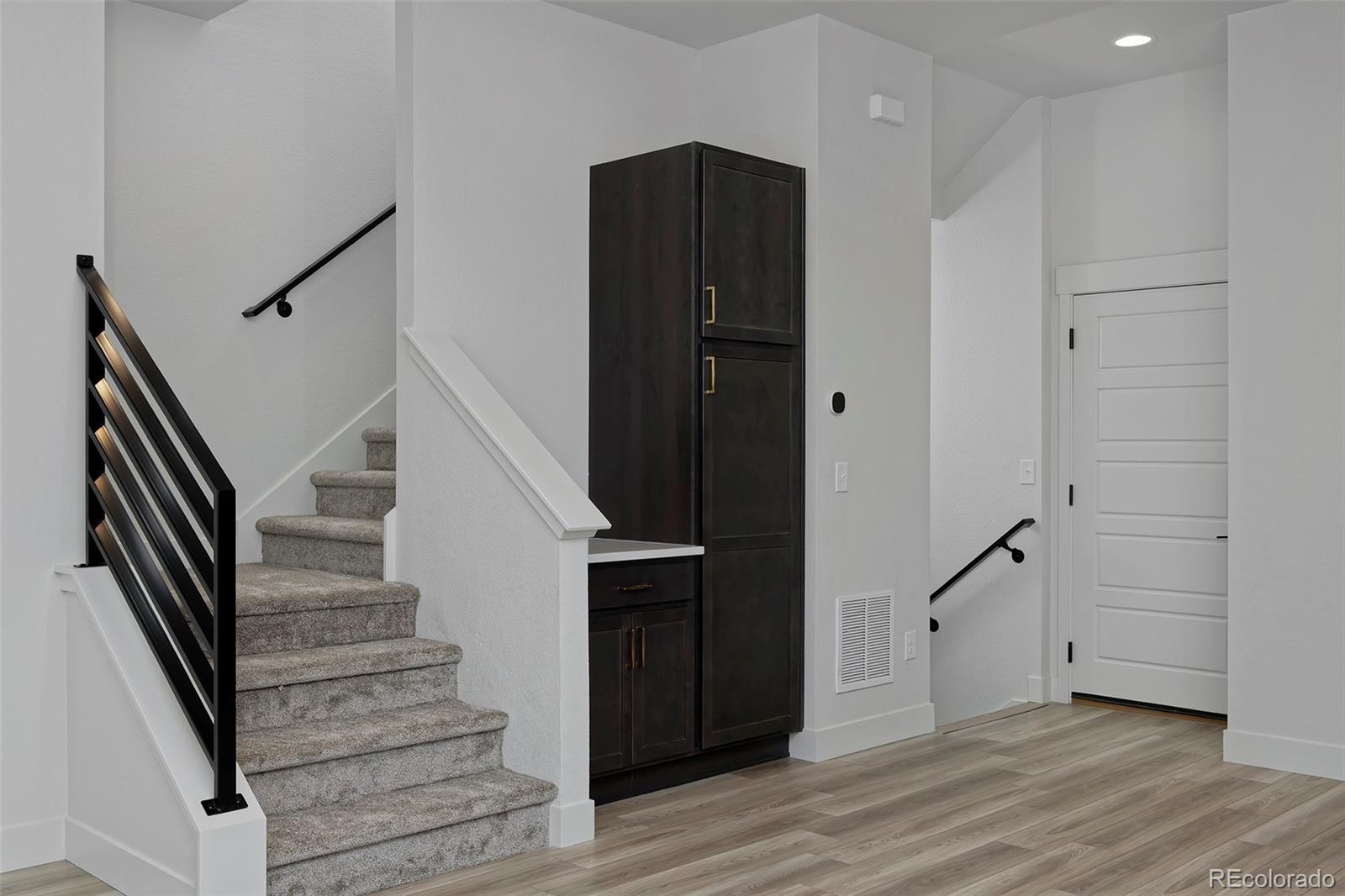 3136 West Bonfils Place Denver, CO 80236 - Photo 18 of 43 a view of entryway with wooden floor and stairs
